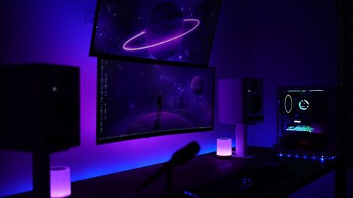 a computer desk with a monitor and speakers